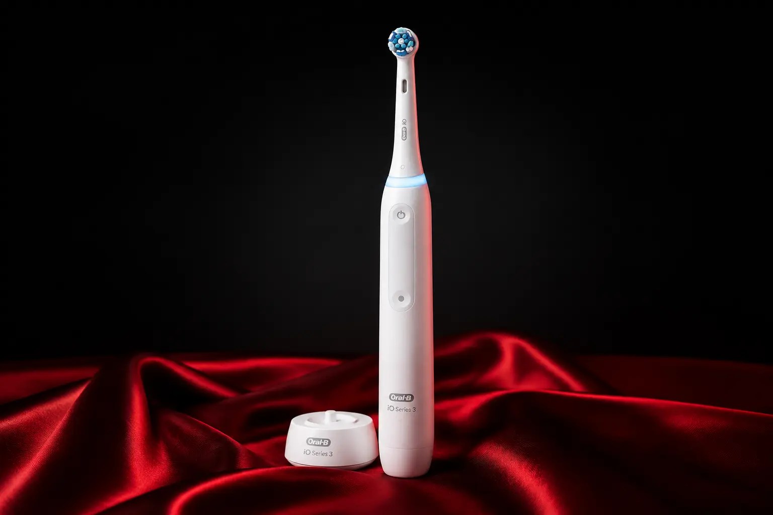 Oral-B iO Series 3 electric toothbrush on red silk
