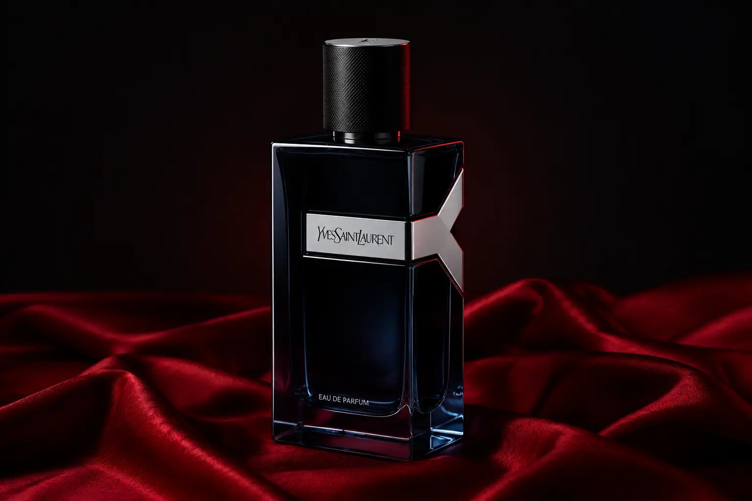 Editorial image of YSL Y Eau de Parfum on red silk