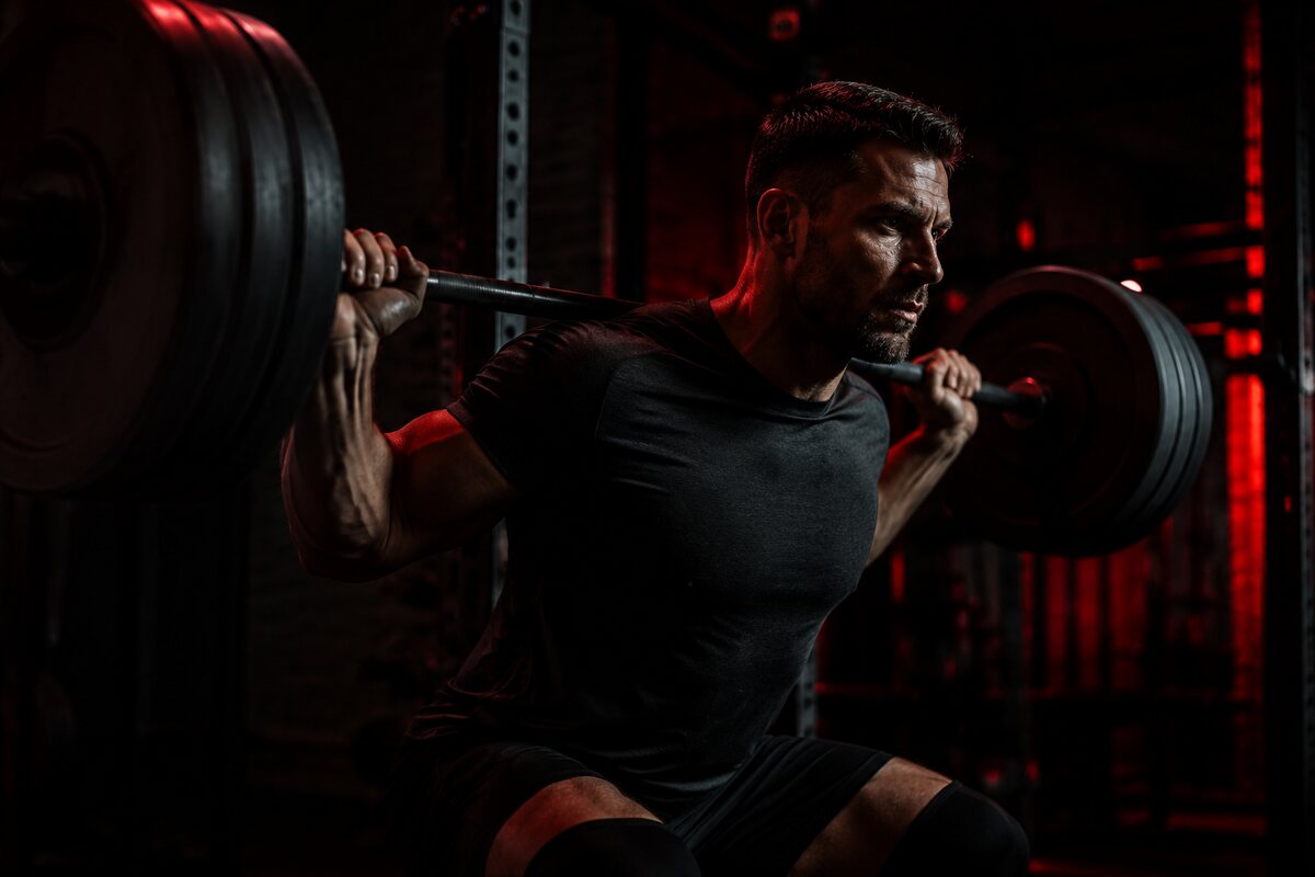 an athletic man maintaining heavy controlled resistance training during a fat-loss phase