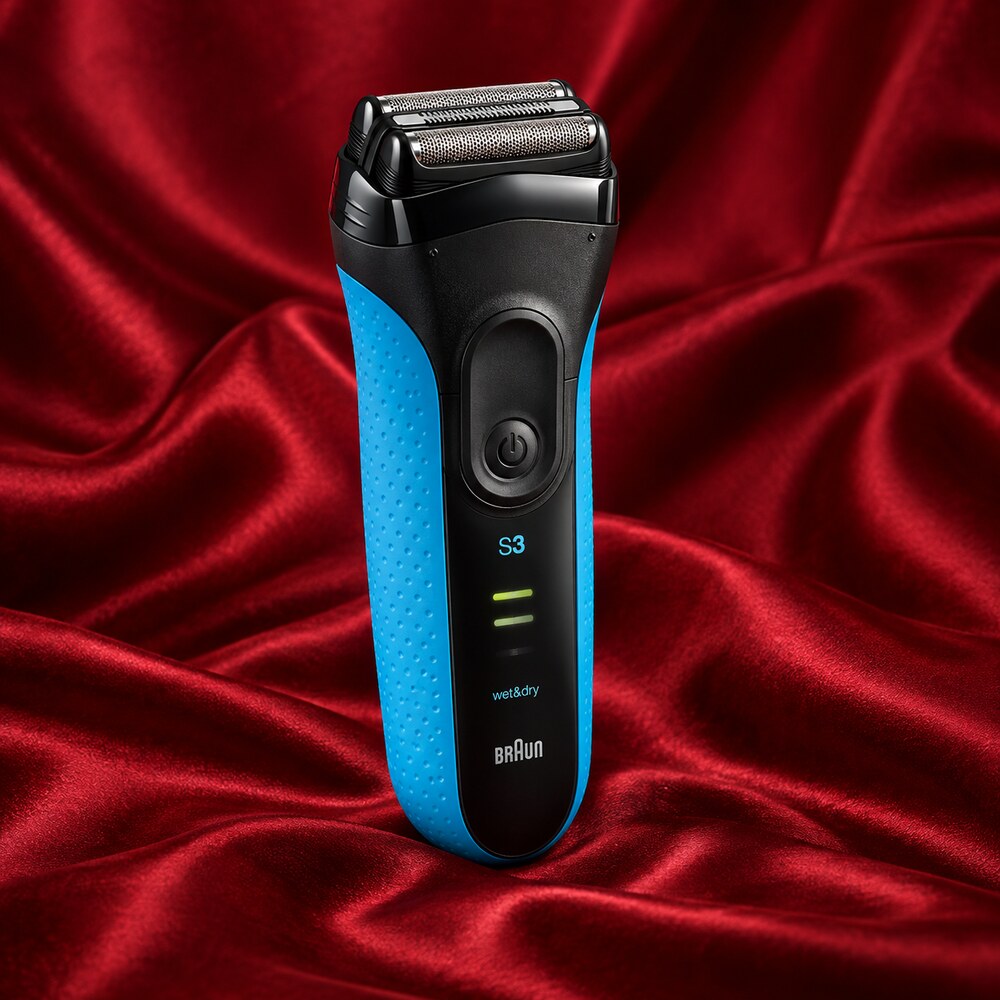 Blue and black Braun Series 3 ProSkin 3040s wet and dry electric shaver displayed on red silk