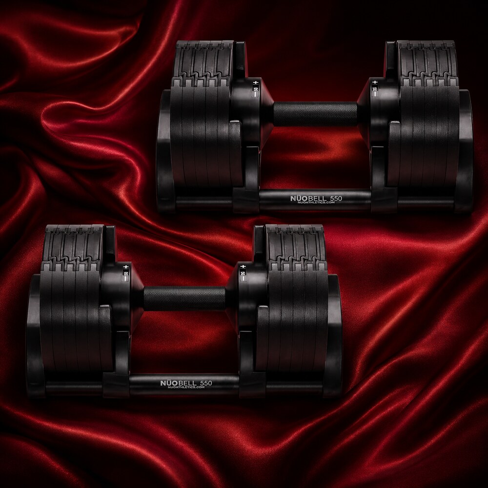Pair of black NÜOBELL adjustable dumbbells displayed on deep red silk