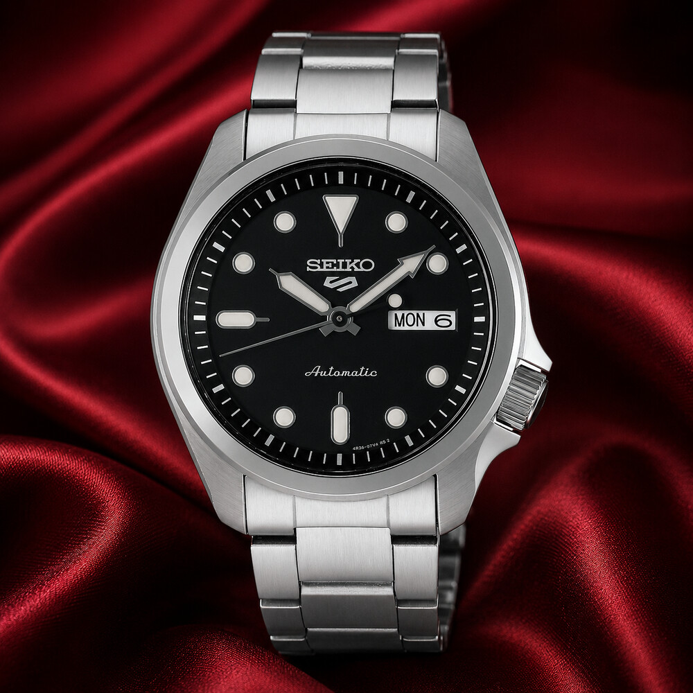 Seiko 5 Sports SRPE55 black-dial automatic watch displayed on deep red silk