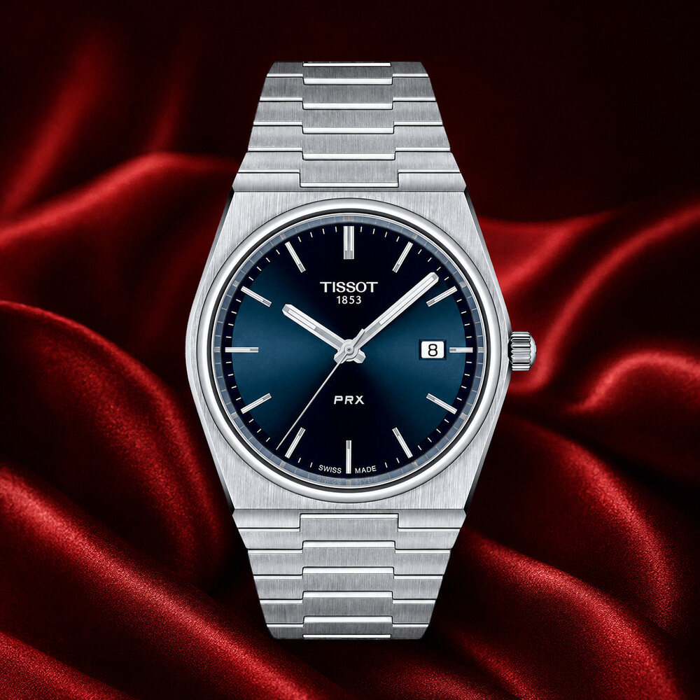 Tissot PRX 40mm Quartz blue-dial watch displayed on deep red silk