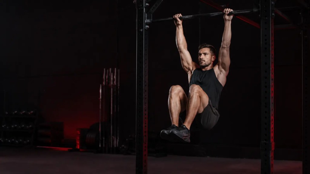 Man performing a controlled hanging knee raise